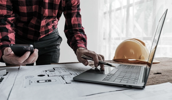 Team reviewing their accounts payable construction reporting on a job site